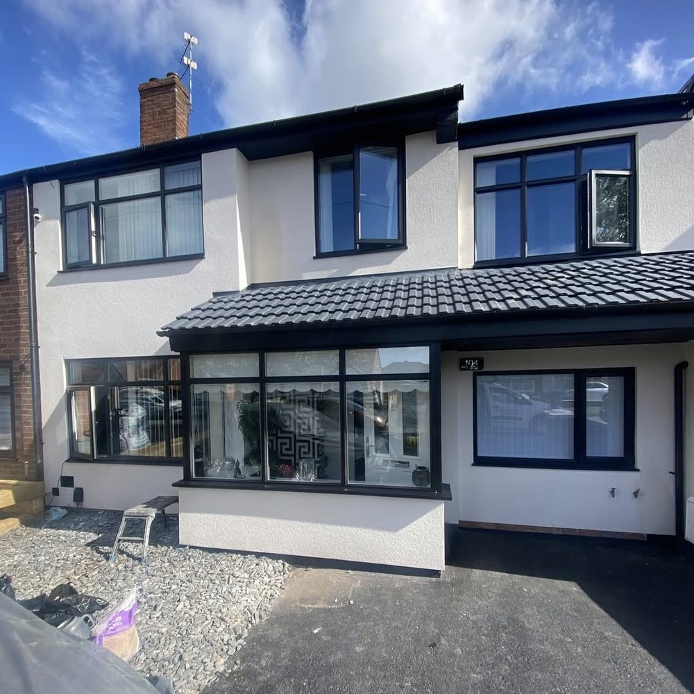 Finished Pro Spray job: semi-detached house with window frames, fascias and soffits resprayed black against white render
